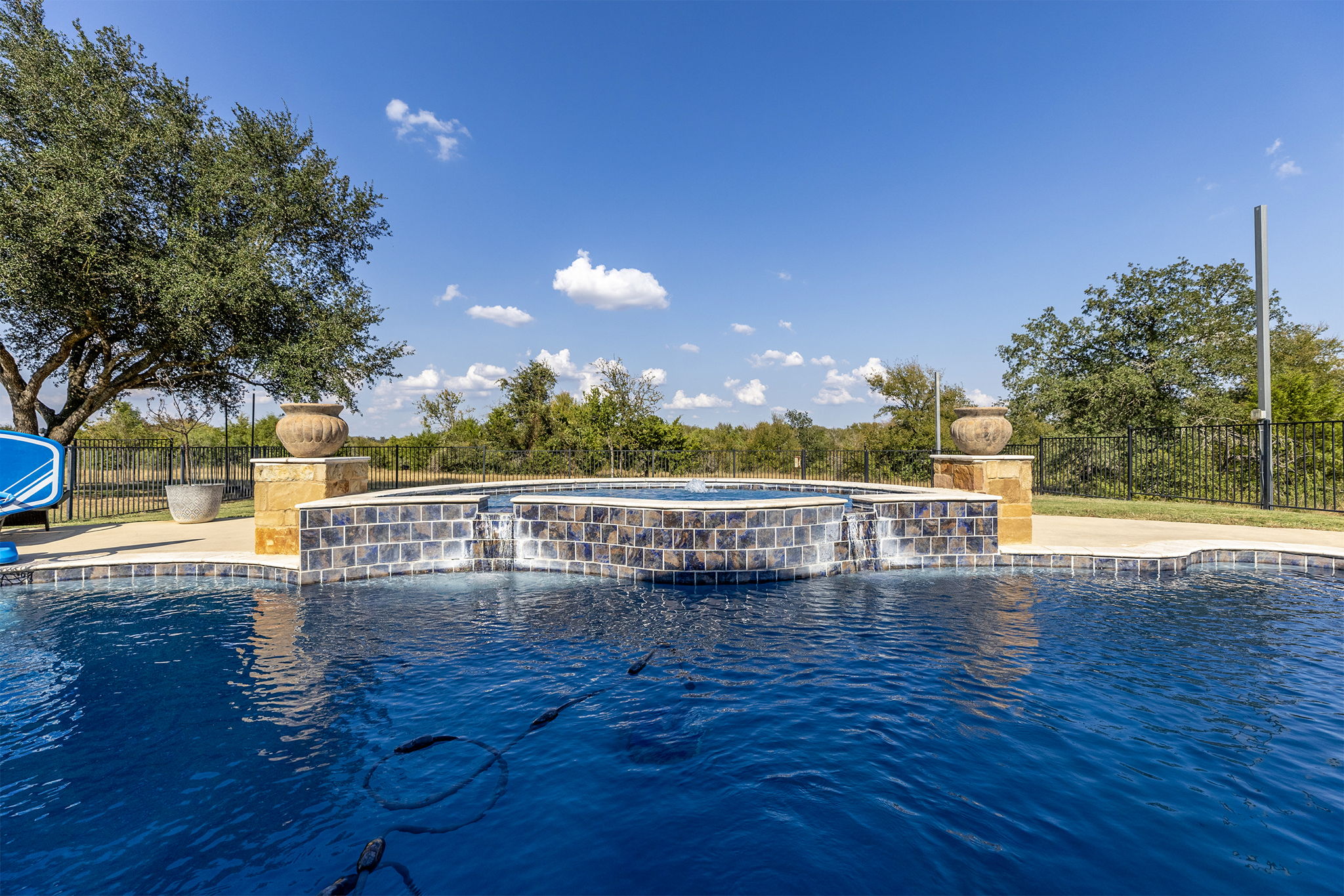 1124 County Road 301 Elgin, TX 78621 - Photo 37 of 40 a view of a swimming pool with deck and lake view