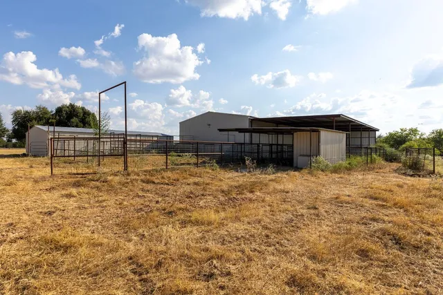 a backyard of a house with table and chairs