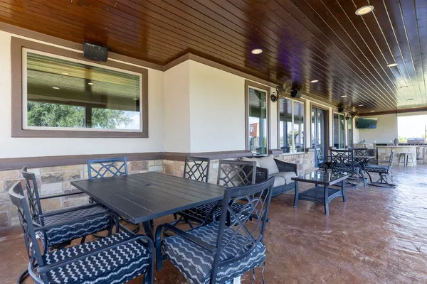 an outdoor patio with table and chairs