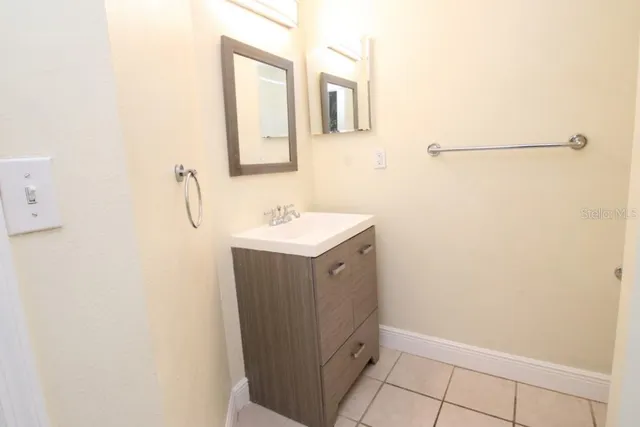 a bathroom with a sink and mirror