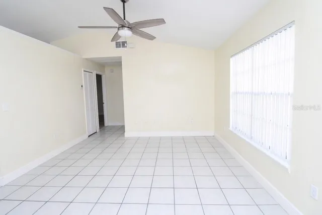 a view of an empty room and a window