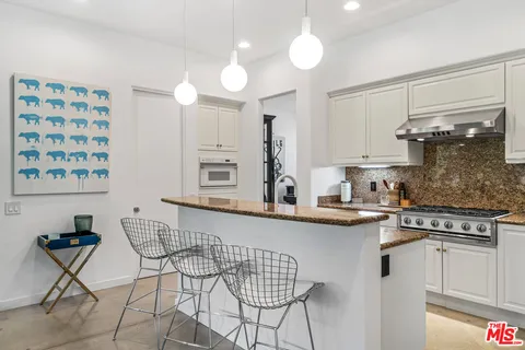 a kitchen with stainless steel appliances granite countertop a sink and cabinets