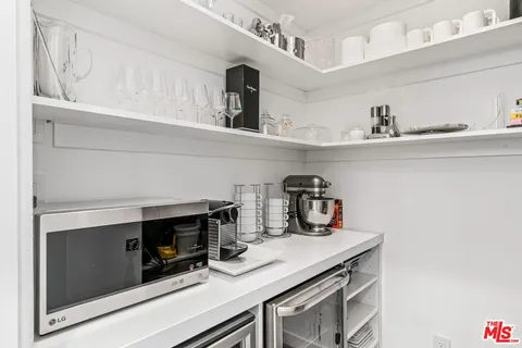 a kitchen with a sink a stove and cabinets