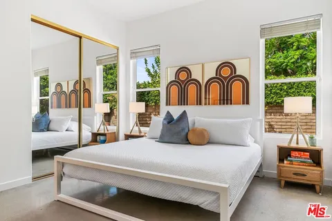 a bedroom with a large bed and a window