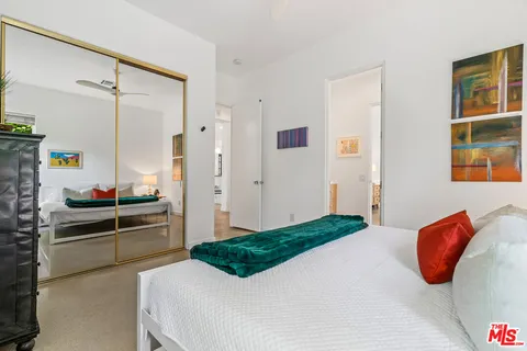 a bed room with a bed and a large window