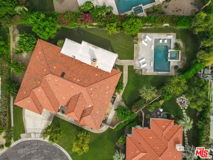 an aerial view of a house with swimming pool patio and outdoor seating