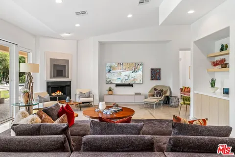 a living room with furniture and a fireplace