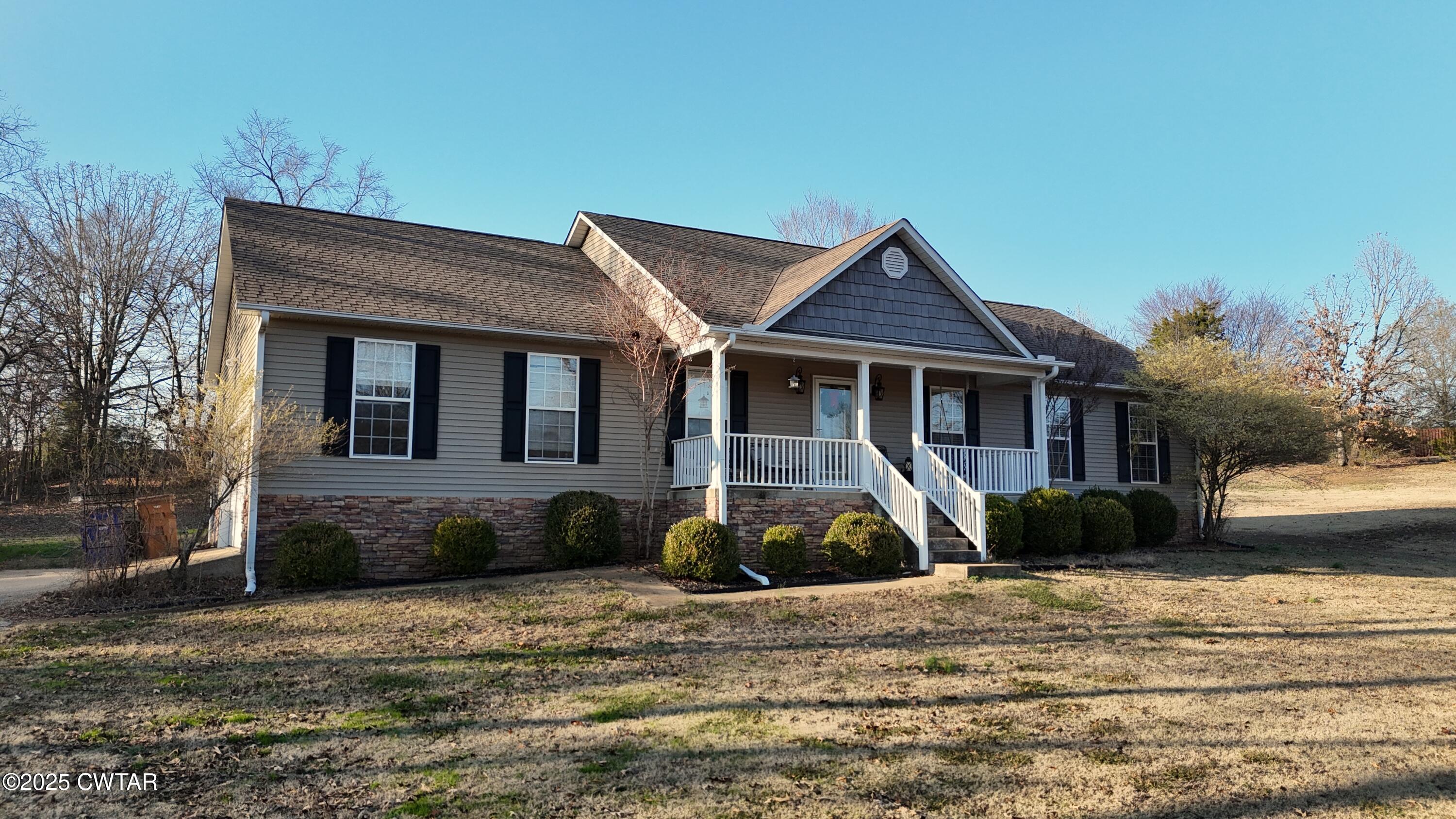759 Timber Ridge Drive Lexington, TN 38351 - Photo 1 of 18 a front view of a house with garden