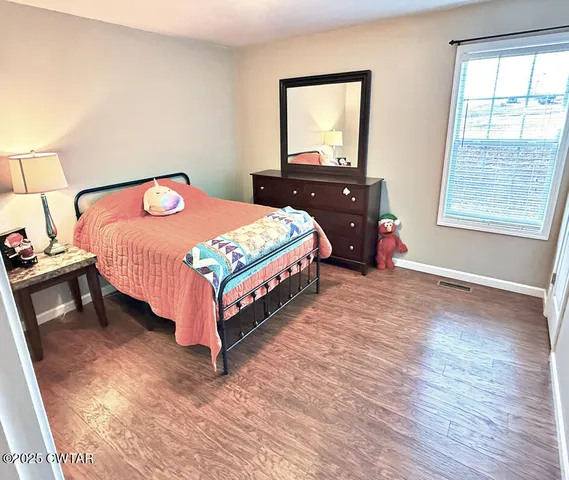 a bedroom with a bed and window