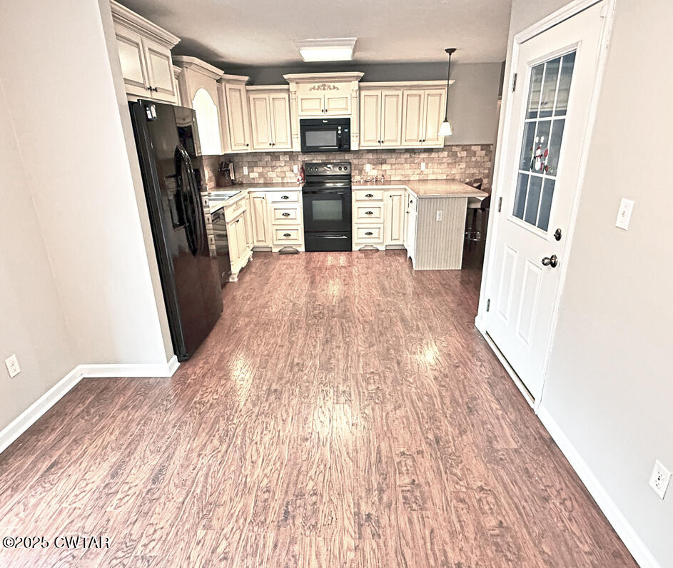 759 Timber Ridge Drive Lexington, TN 38351 - Photo 4 of 18 a kitchen with refrigerator a stove top oven and cabinets