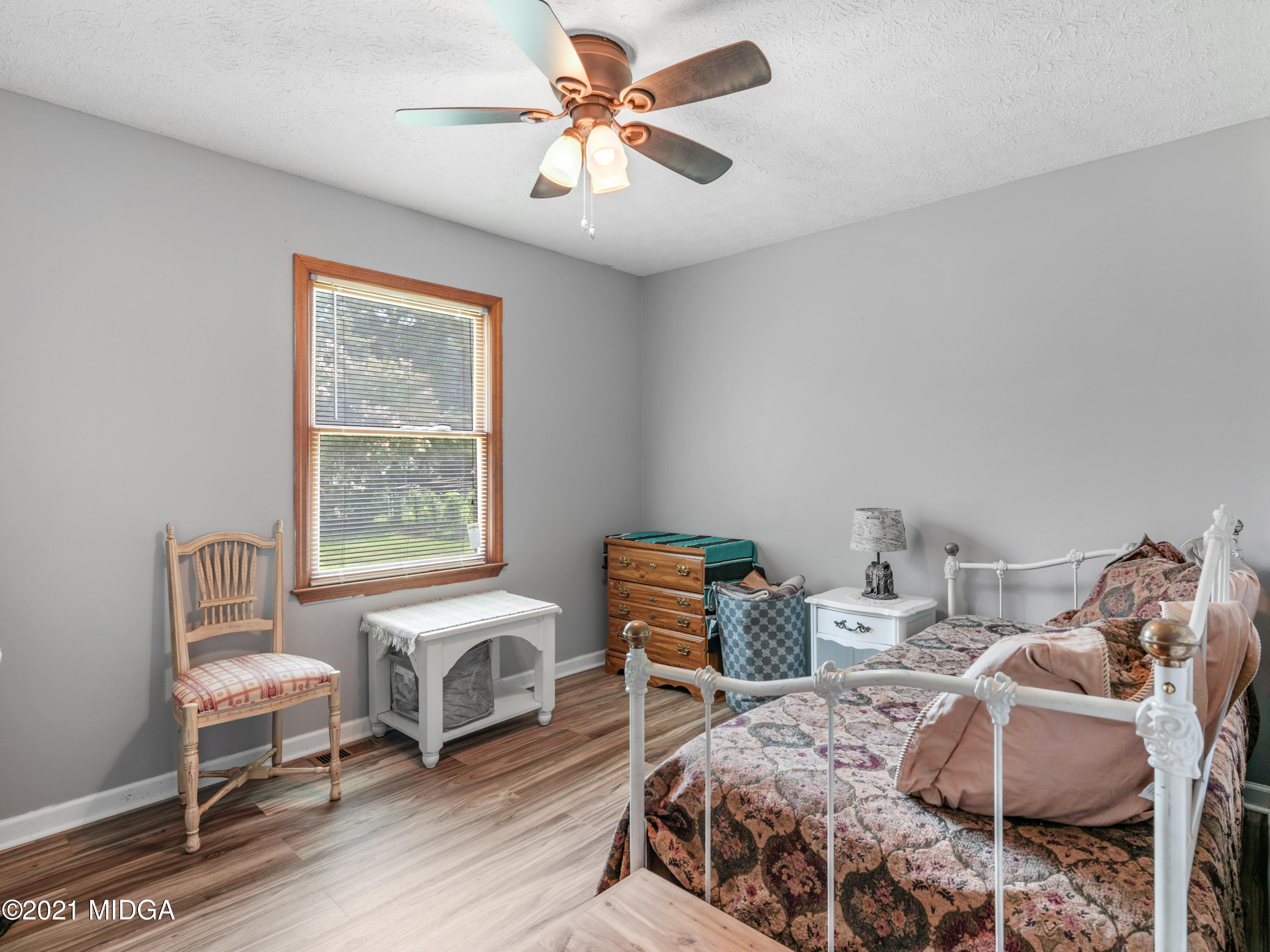 747 Chuli Road Griffin, GA 30223 - Photo 21 of 45 a bedroom with a bed and a chair