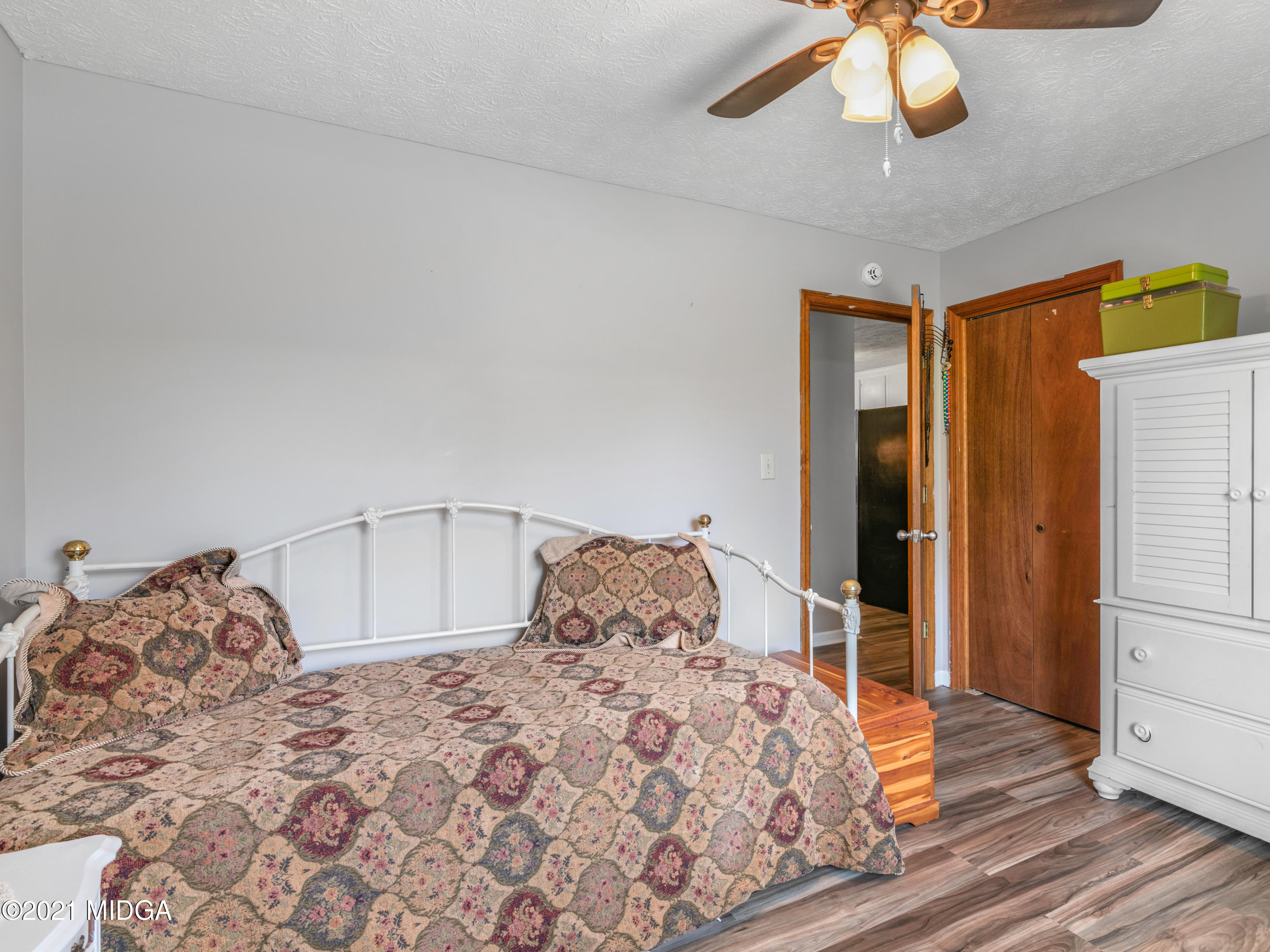 747 Chuli Road Griffin, GA 30223 - Photo 22 of 45 a bedroom with a large bed and a chandelier