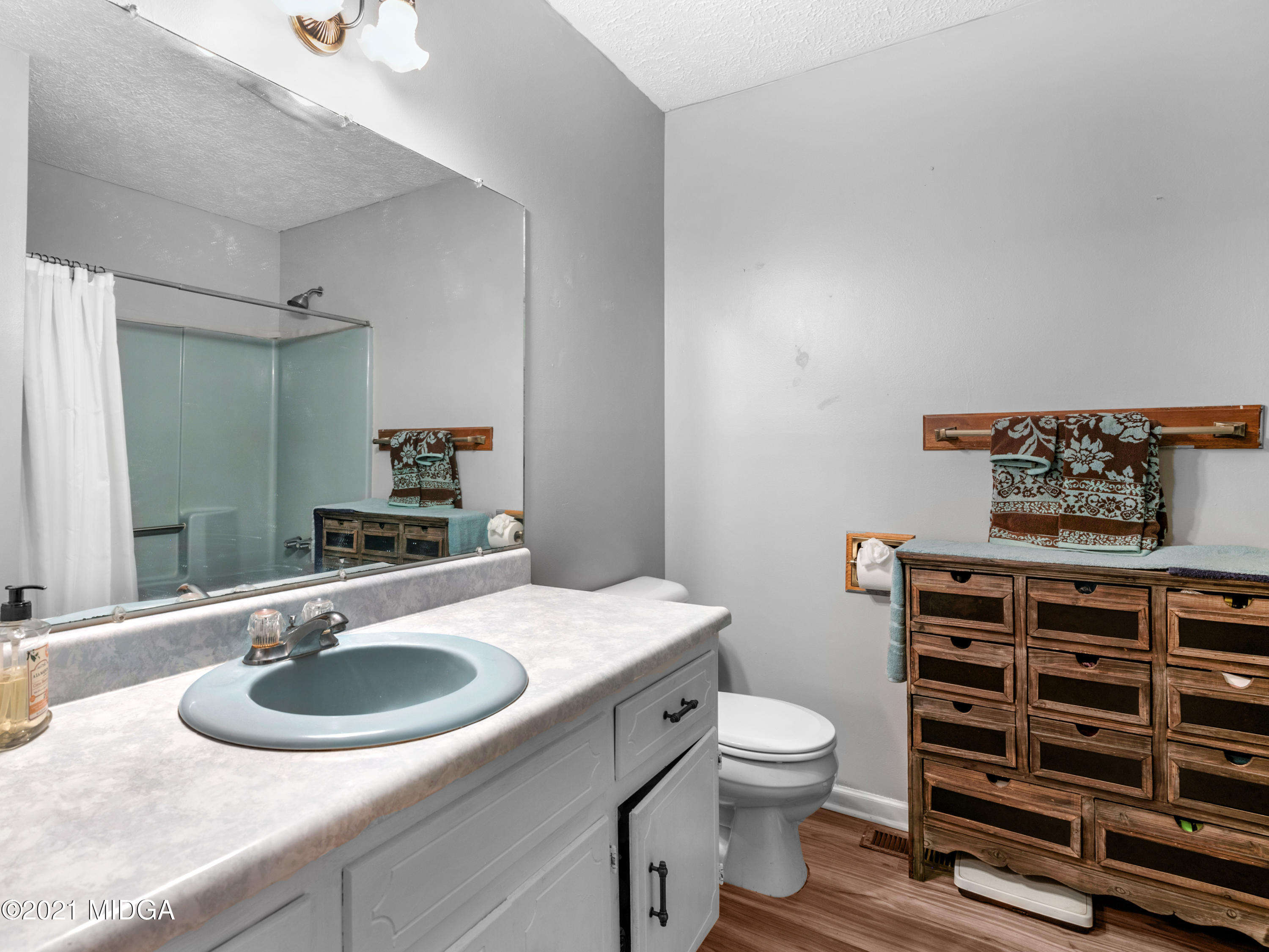 747 Chuli Road Griffin, GA 30223 - Photo 24 of 45 a bathroom with a sink toilet and a mirror