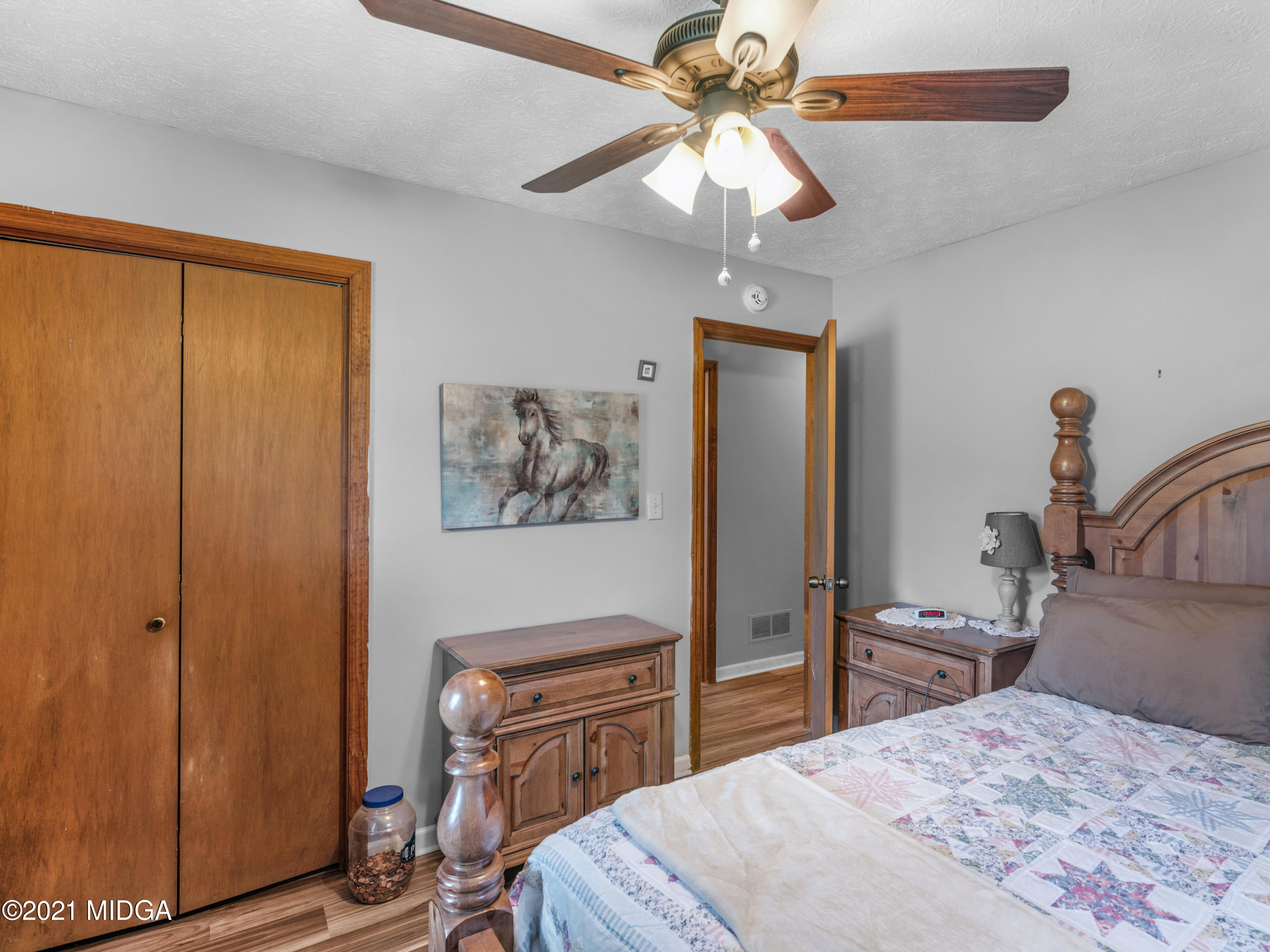 747 Chuli Road Griffin, GA 30223 - Photo 27 of 45 a bedroom with a bed and a chandelier