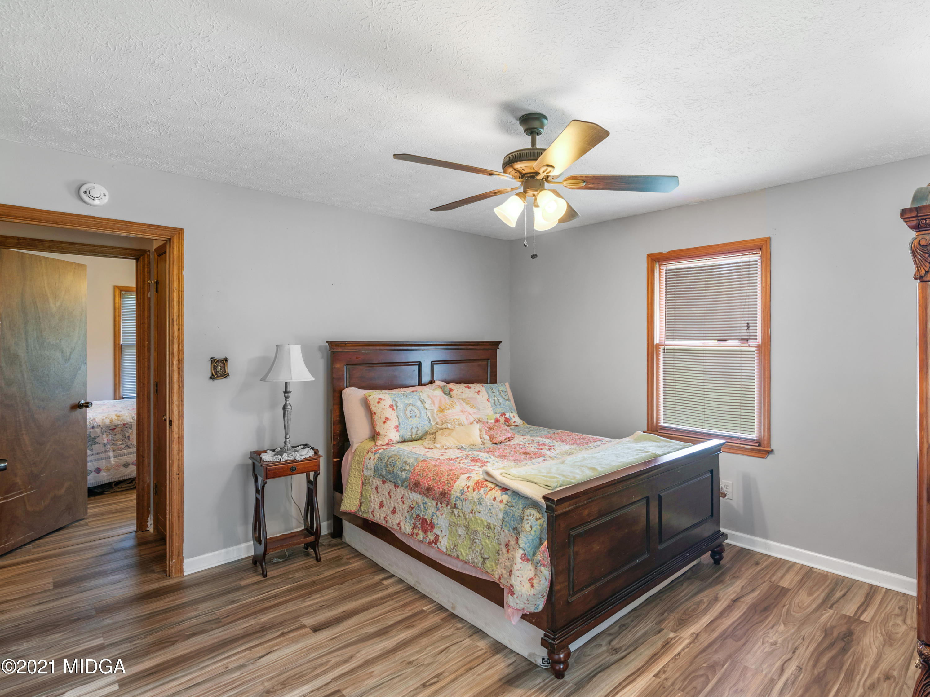 747 Chuli Road Griffin, GA 30223 - Photo 29 of 45 a bedroom with a bed and a chandelier