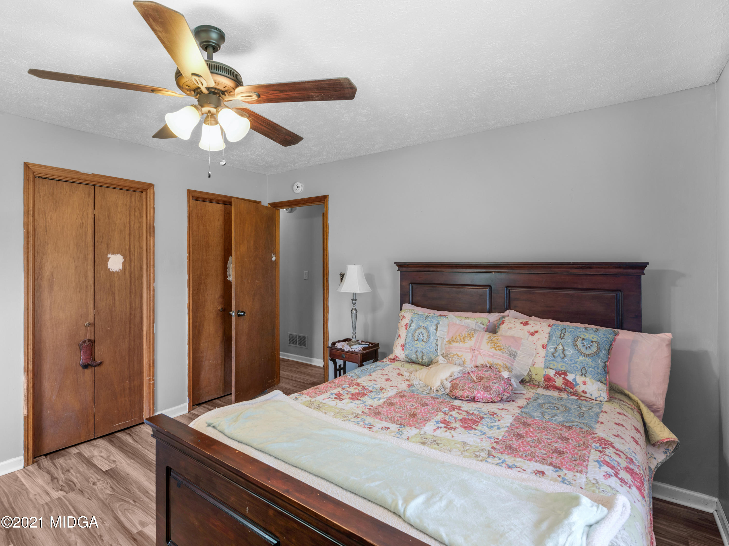 747 Chuli Road Griffin, GA 30223 - Photo 30 of 45 a bedroom with a bed and a chandelier