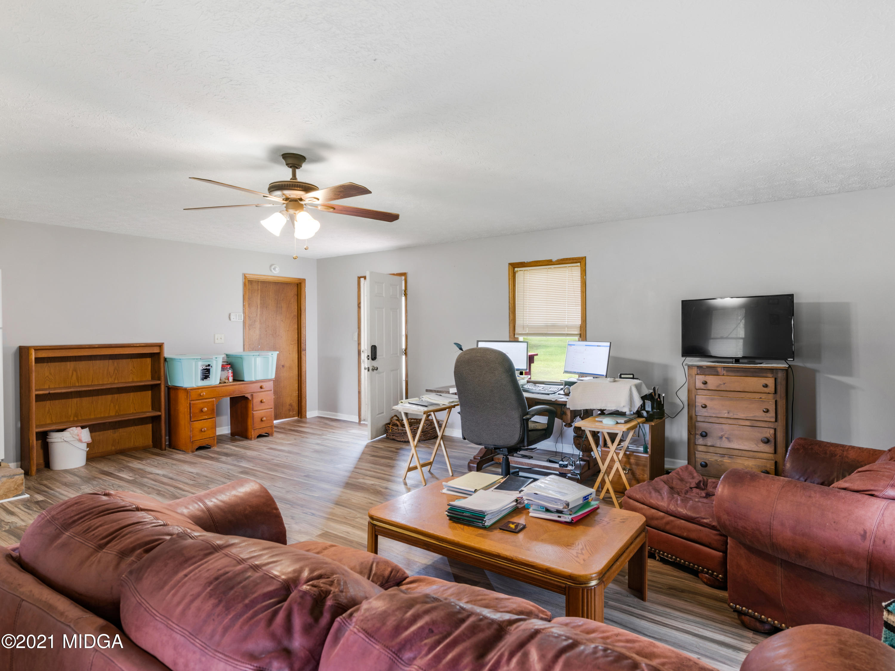 747 Chuli Road Griffin, GA 30223 - Photo 33 of 45 a living room with furniture and a flat screen tv