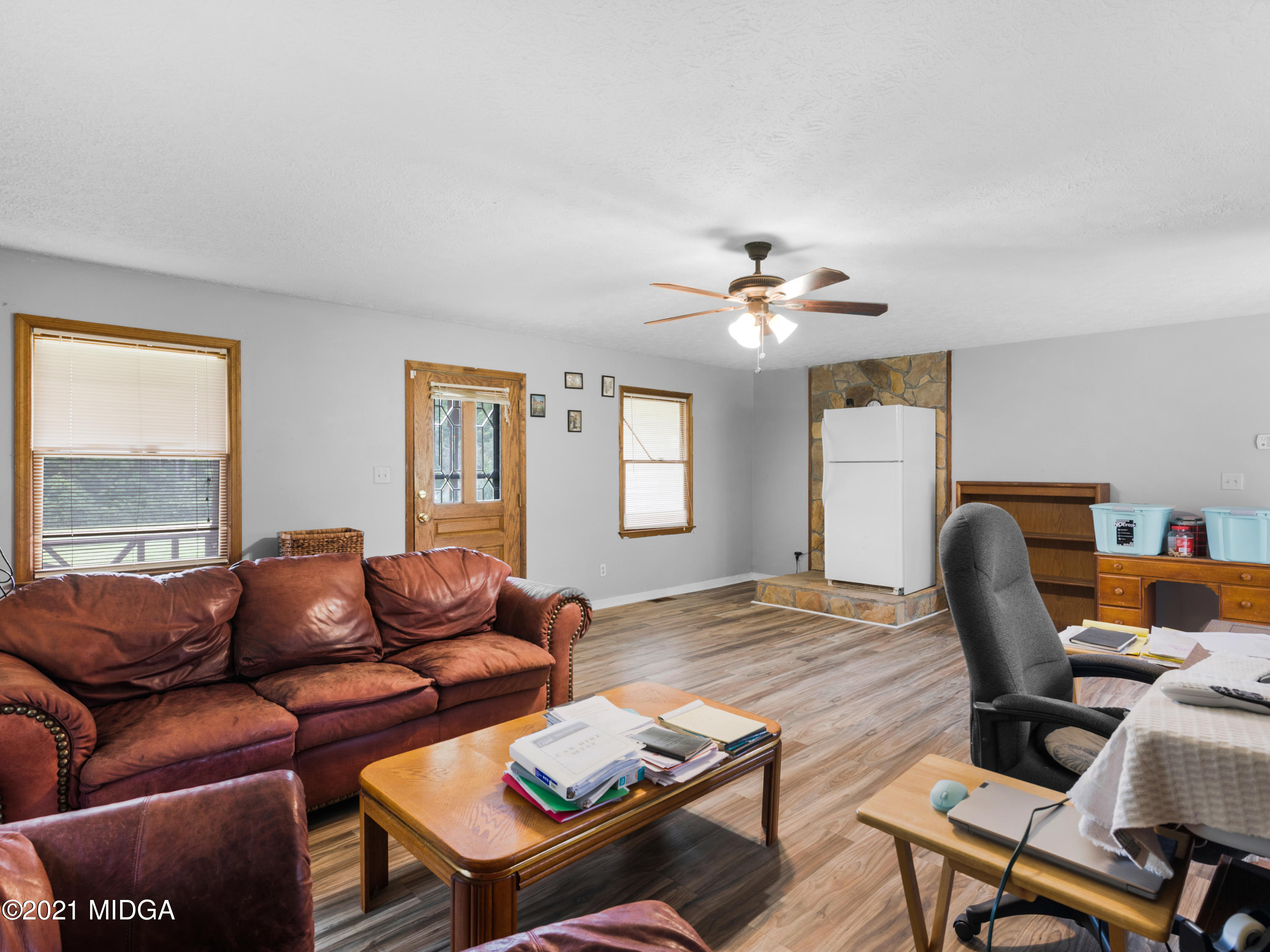 747 Chuli Road Griffin, GA 30223 - Photo 34 of 45 a living room with furniture a desk and chair with wooden floor