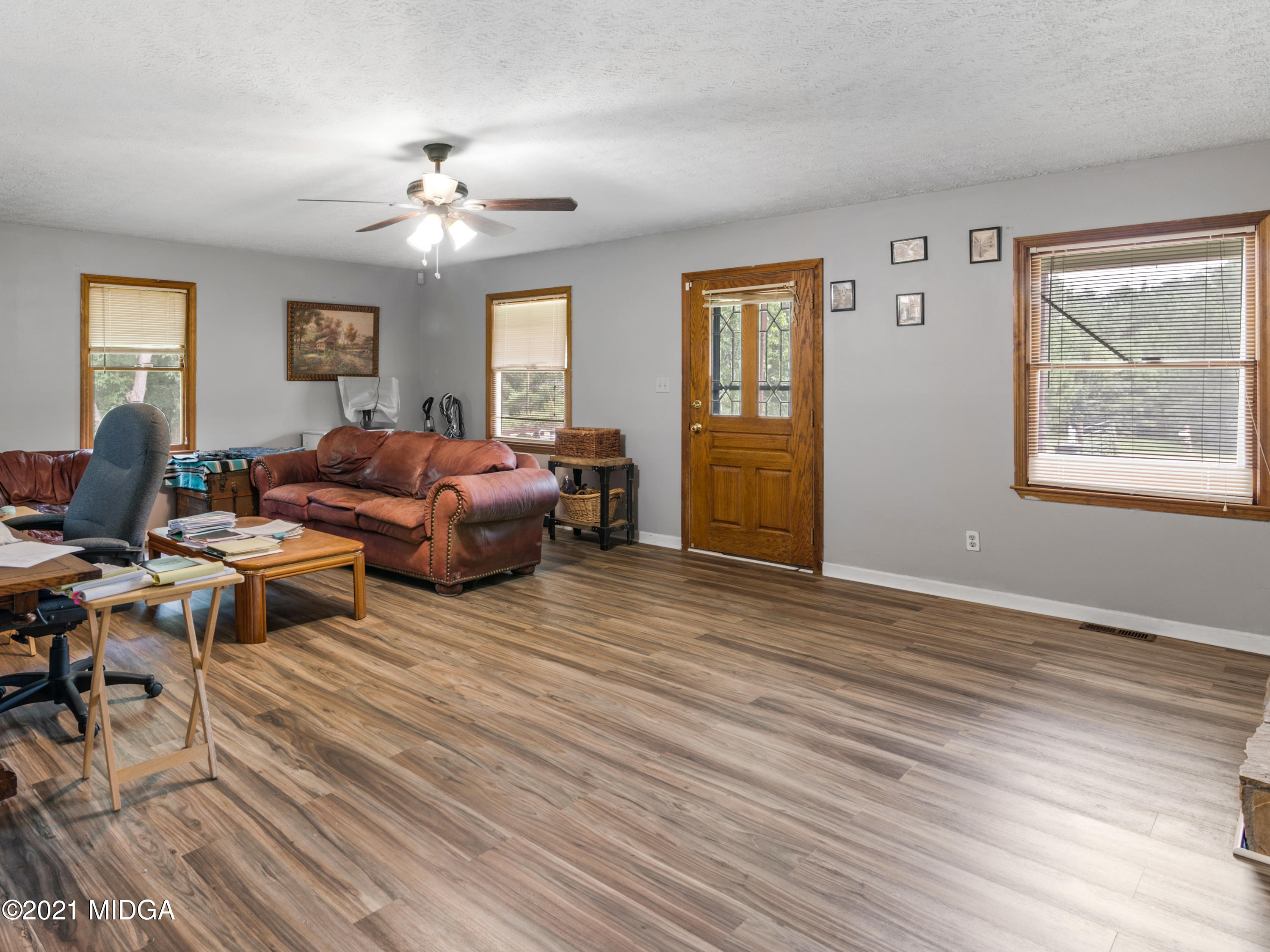 747 Chuli Road Griffin, GA 30223 - Photo 35 of 45 a living room with furniture a chandelier and a window