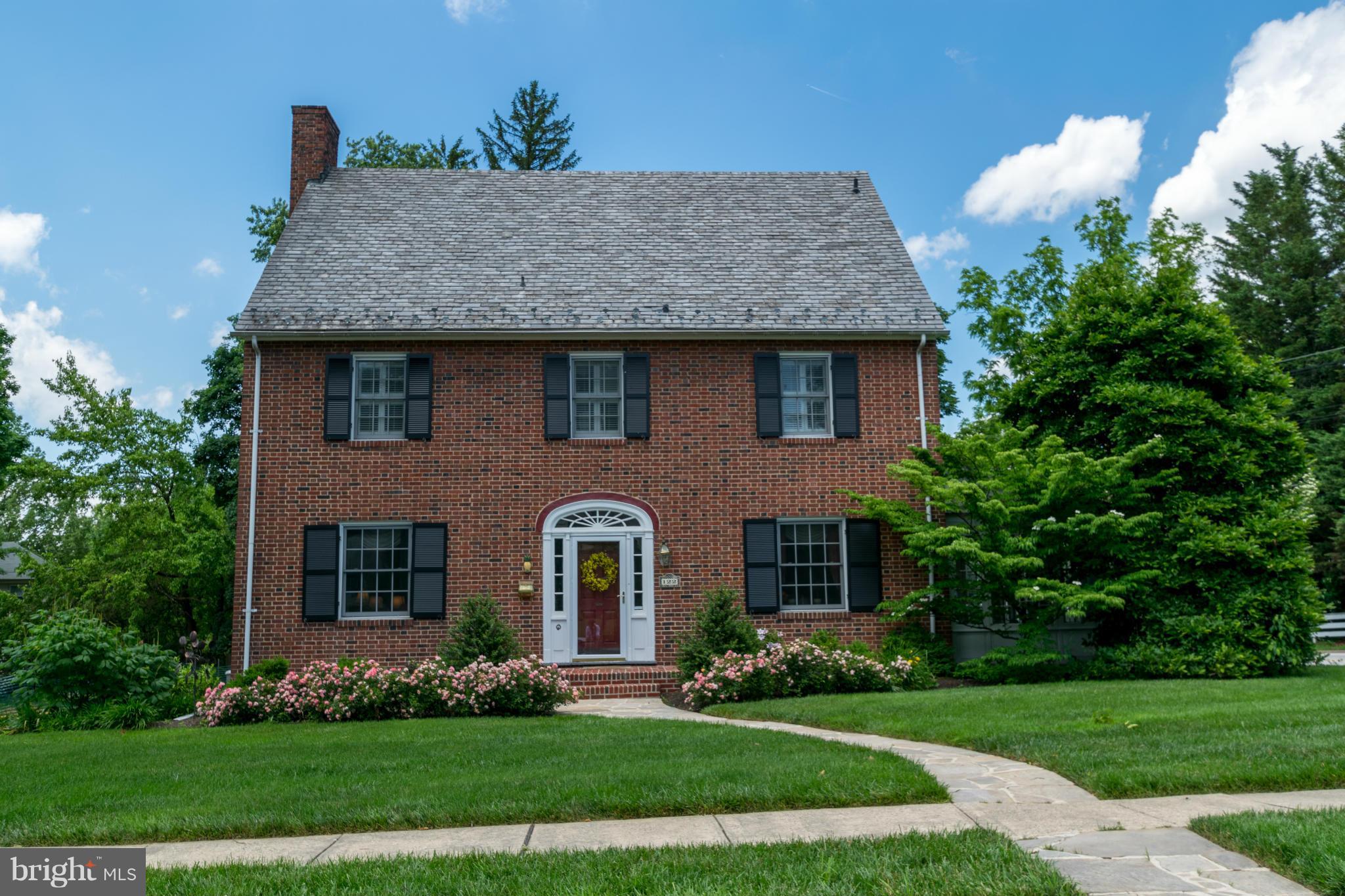 122 Midhurst Road Baltimore, MD 21212 - Photo 1 of 21 a front view of a house with a garden and plants
