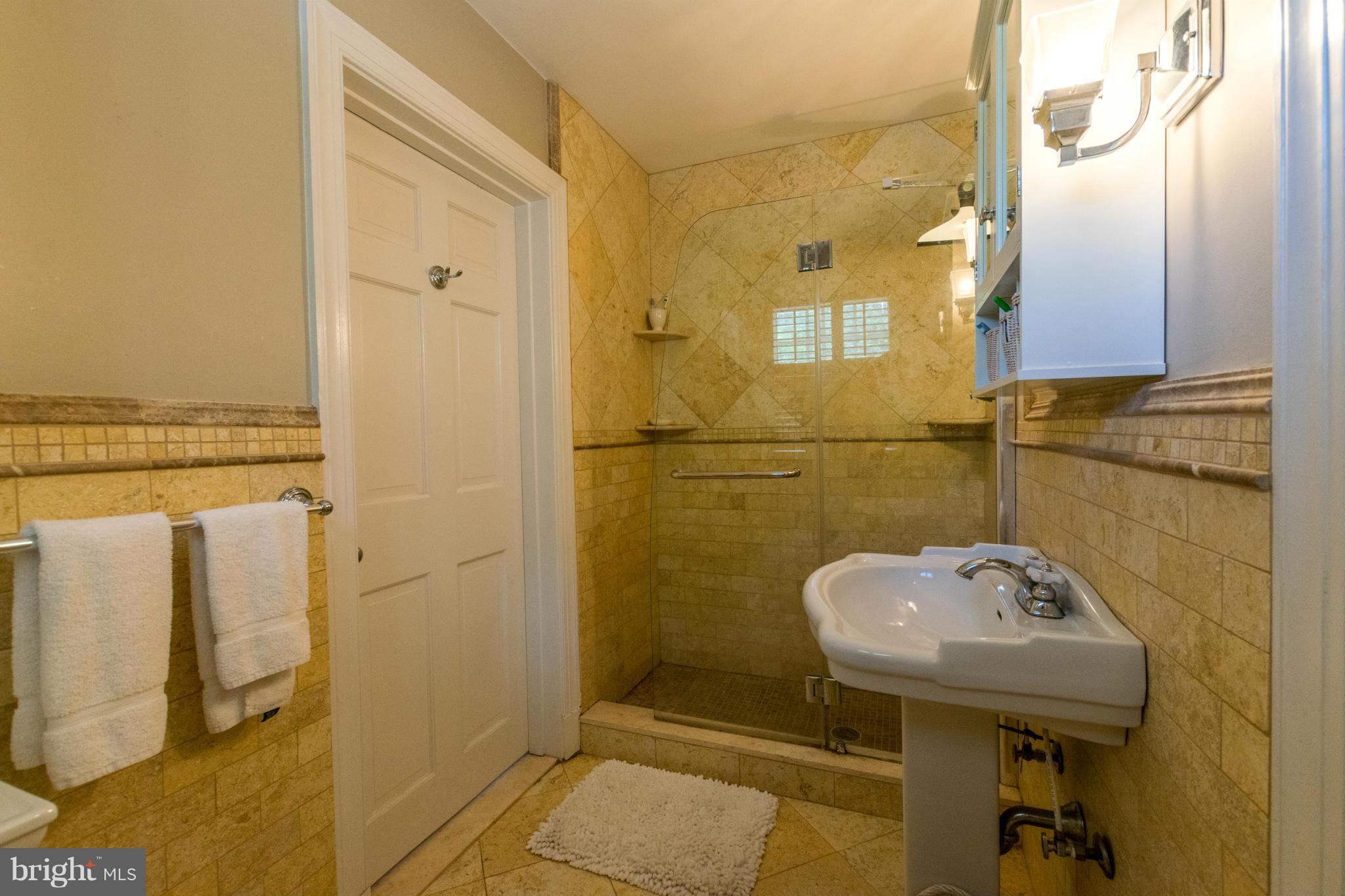 122 Midhurst Road Baltimore, MD 21212 - Photo 18 of 21 a bathroom with a sink a toilet and shower
