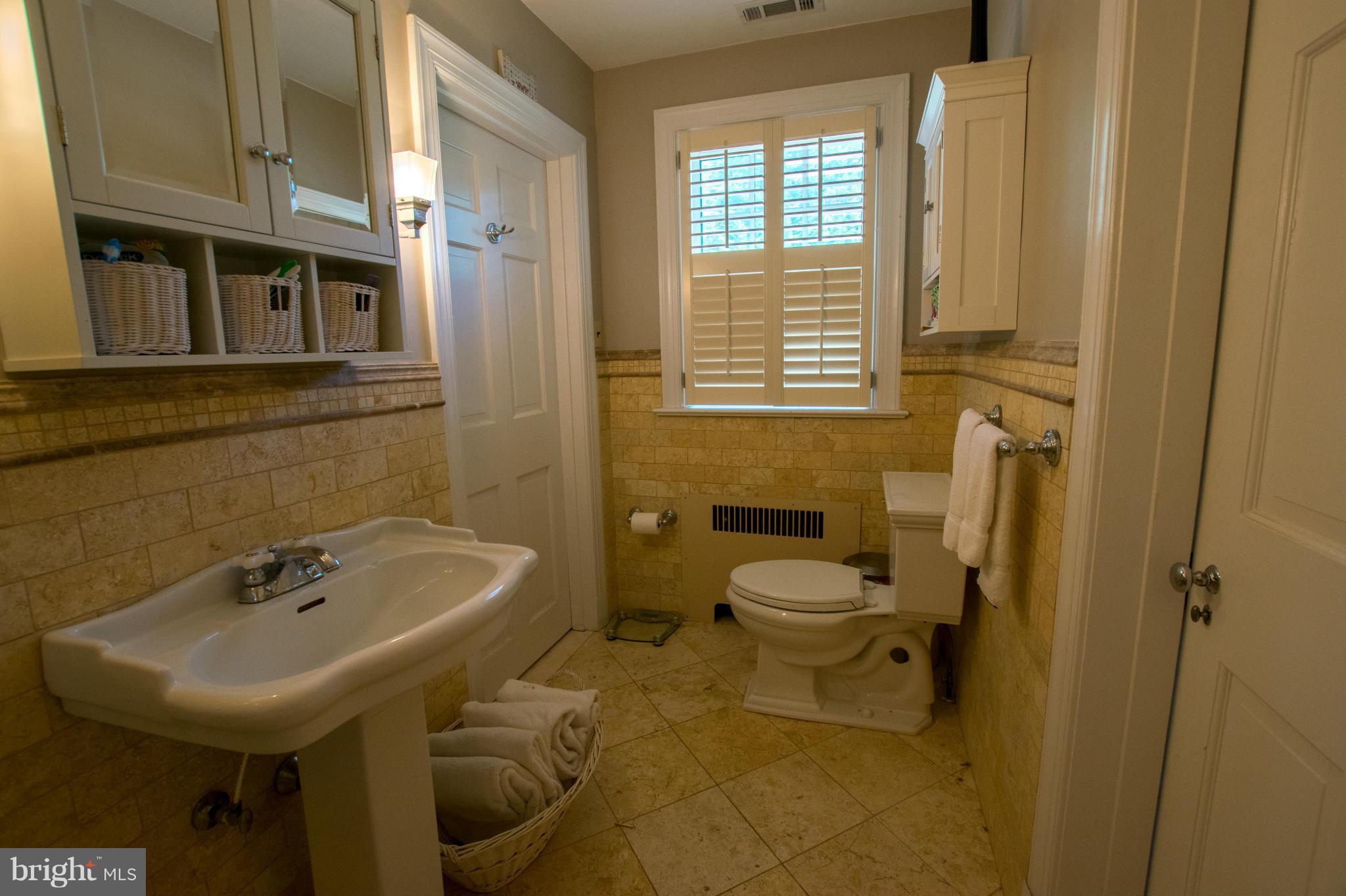 122 Midhurst Road Baltimore, MD 21212 - Photo 19 of 21 a bathroom with a sink a toilet and shower