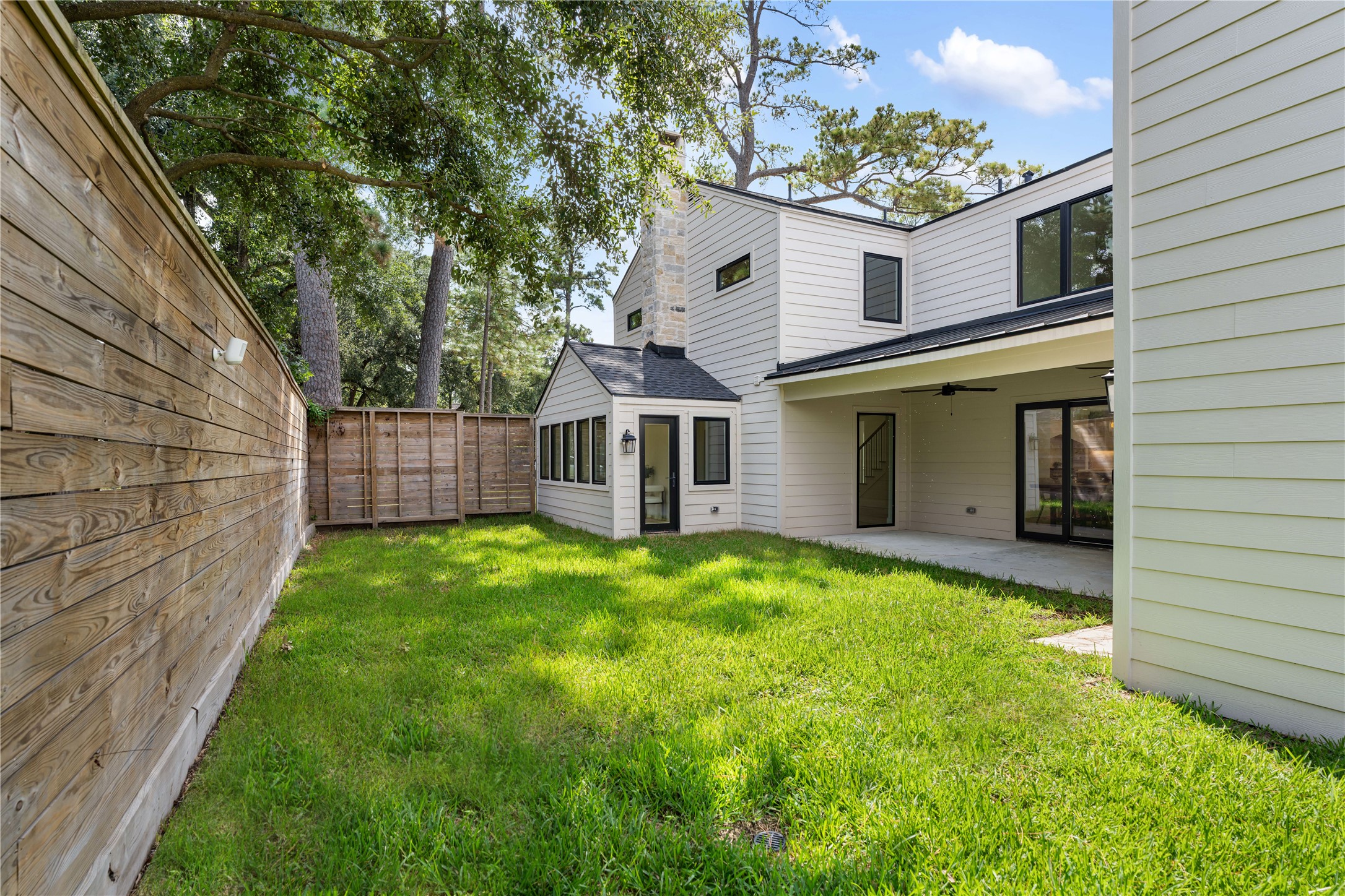 814 Azalea Street Houston, TX 77018 - Photo 28 of 31 Alternate view highlighting the generous yard space, mature trees, and covered patio—ideal for future pool or outdoor entertaining.