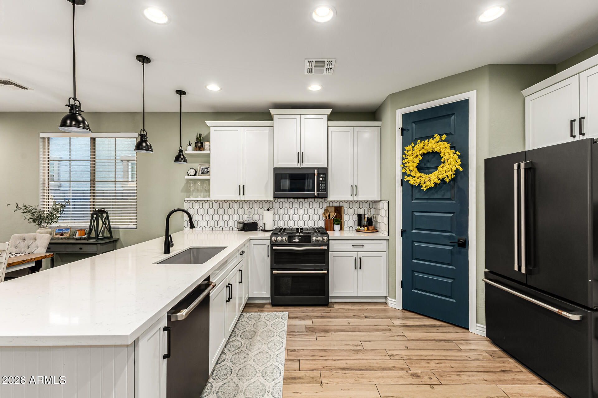 20416 Rosa Road Queen Creek, AZ 85142 - Photo 17 of 51 a kitchen with stainless steel appliances granite countertop a refrigerator a stove a sink and a microwave