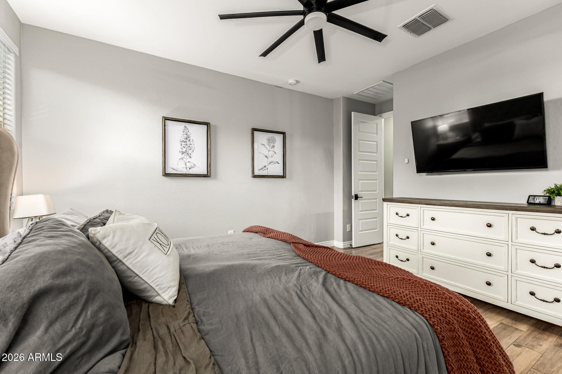 20416 Rosa Road Queen Creek, AZ 85142 - Photo 21 of 51 a bedroom with a large bed and a flat screen tv