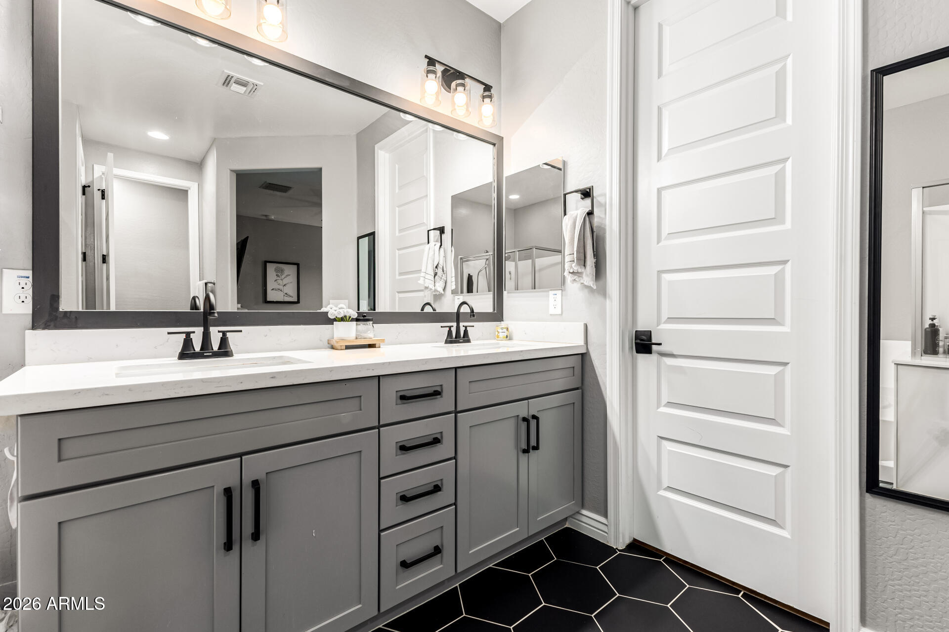 20416 Rosa Road Queen Creek, AZ 85142 - Photo 24 of 51 a bathroom with a double vanity sink a mirror and a shower