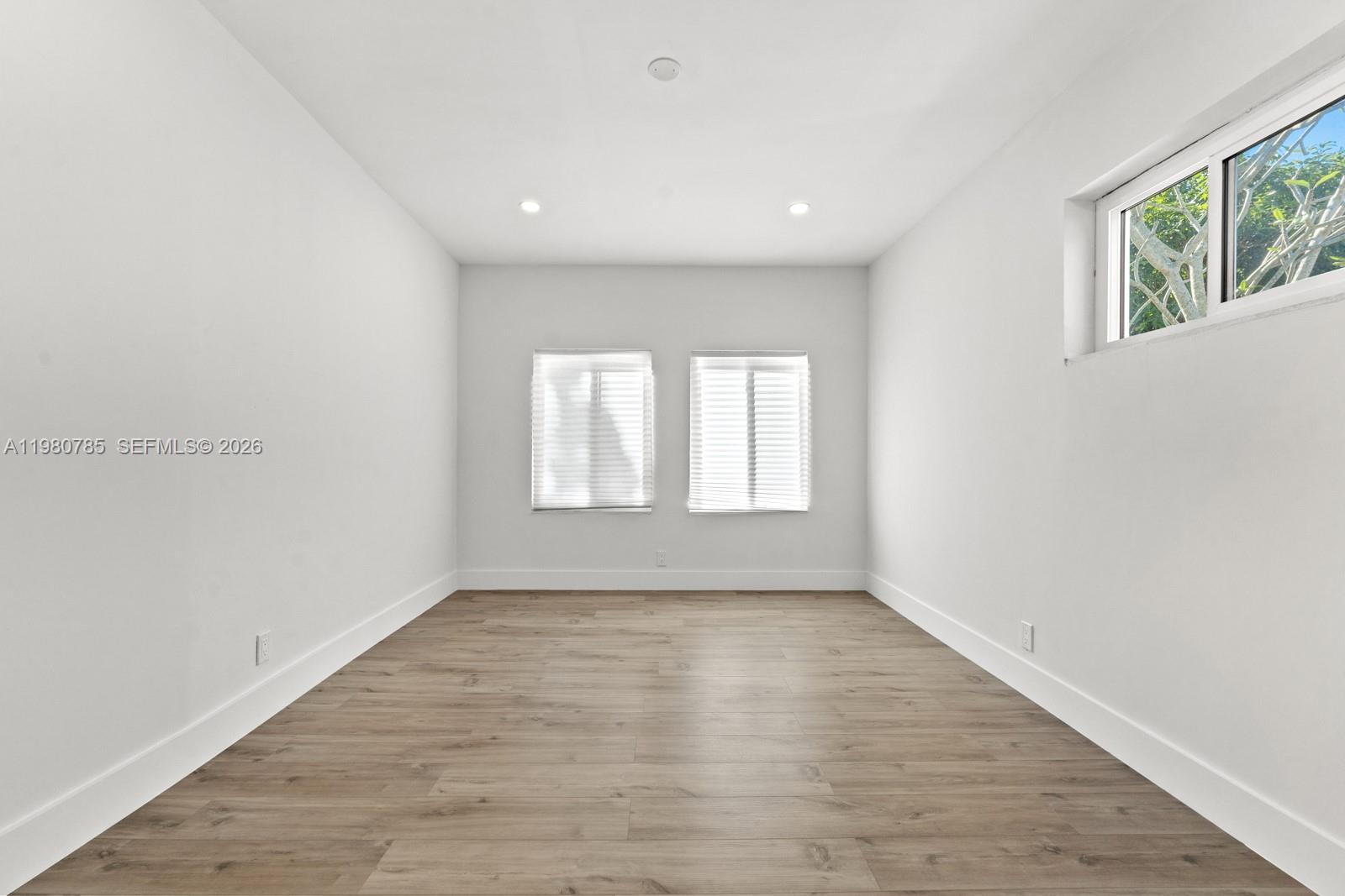 7971 Northwest 3rd Place Margate, FL 33063 - Photo 20 of 41 wooden floor in an empty room with a window