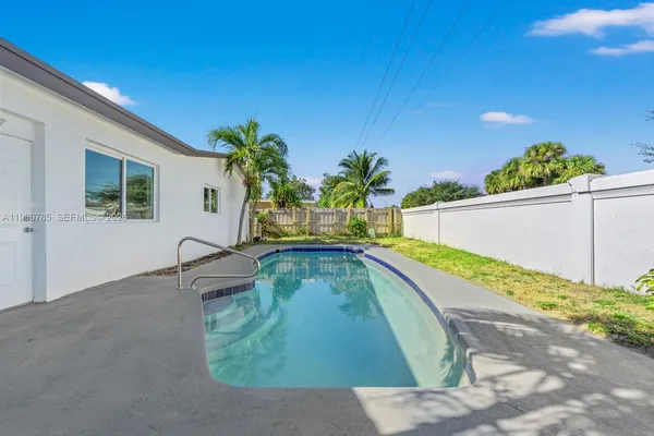 a view of swimming pool with a patio