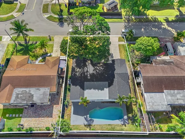 an aerial view of residential houses with outdoor space