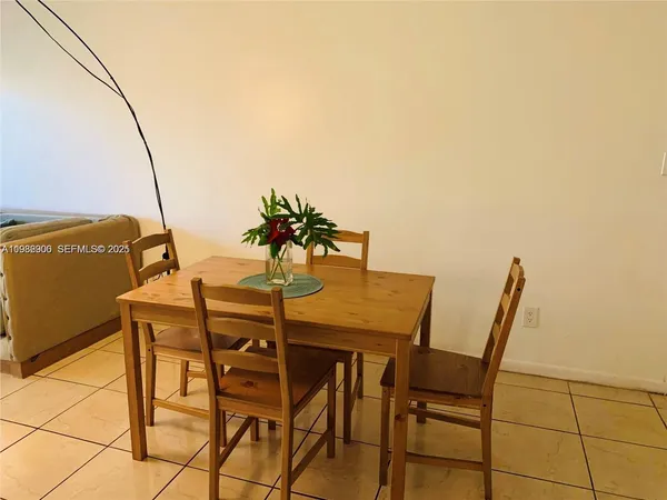 a view of a dining room with furniture and a potted plant