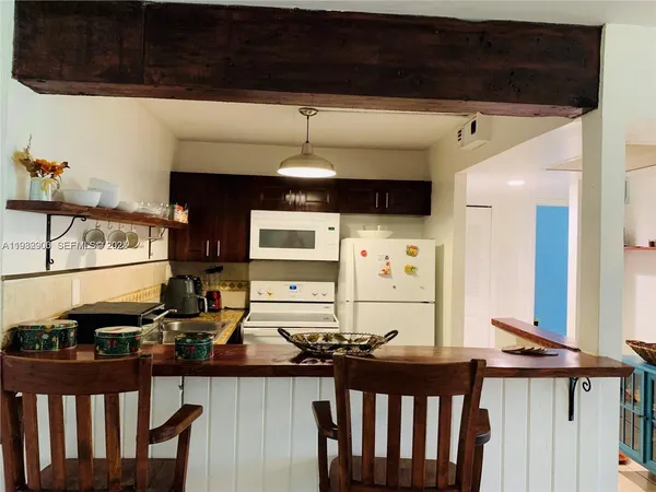 a kitchen with stainless steel appliances kitchen island granite countertop a sink and cabinets