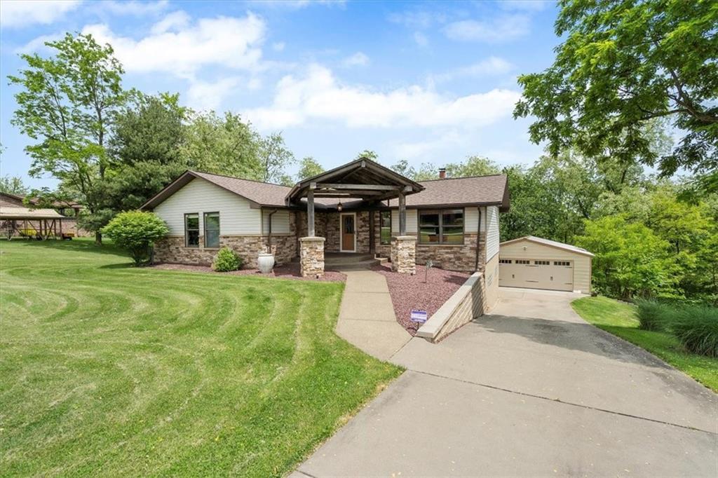 a front view of a house with garden