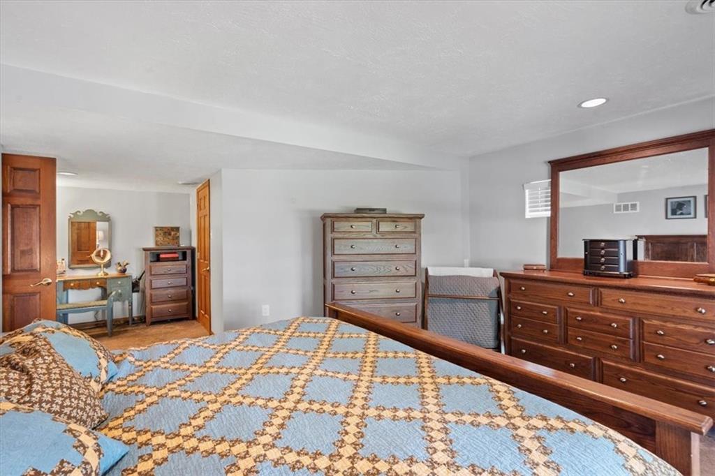 284 McKee Road Washington, PA 15301 - Photo 23 of 35 a bedroom with a bed and dresser with mirror