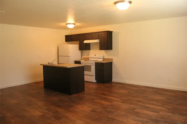 a view of a kitchen with wooden floor