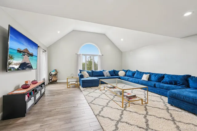 a spacious bedroom with a bed a mirror and a table