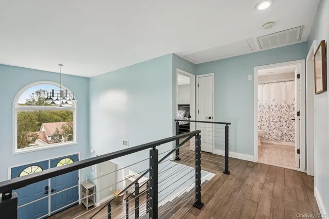 a kitchen that has a lot of cabinets in it and wooden floor