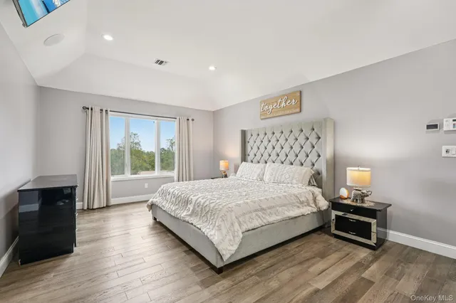 a view of a swimming pool with a bench and trees