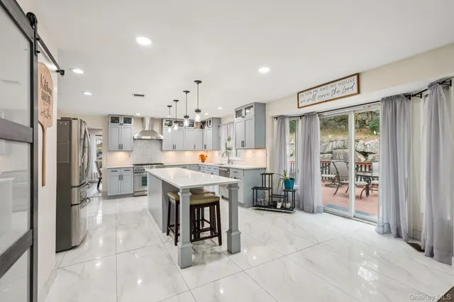 a view of a living room and dining room with wooden floor