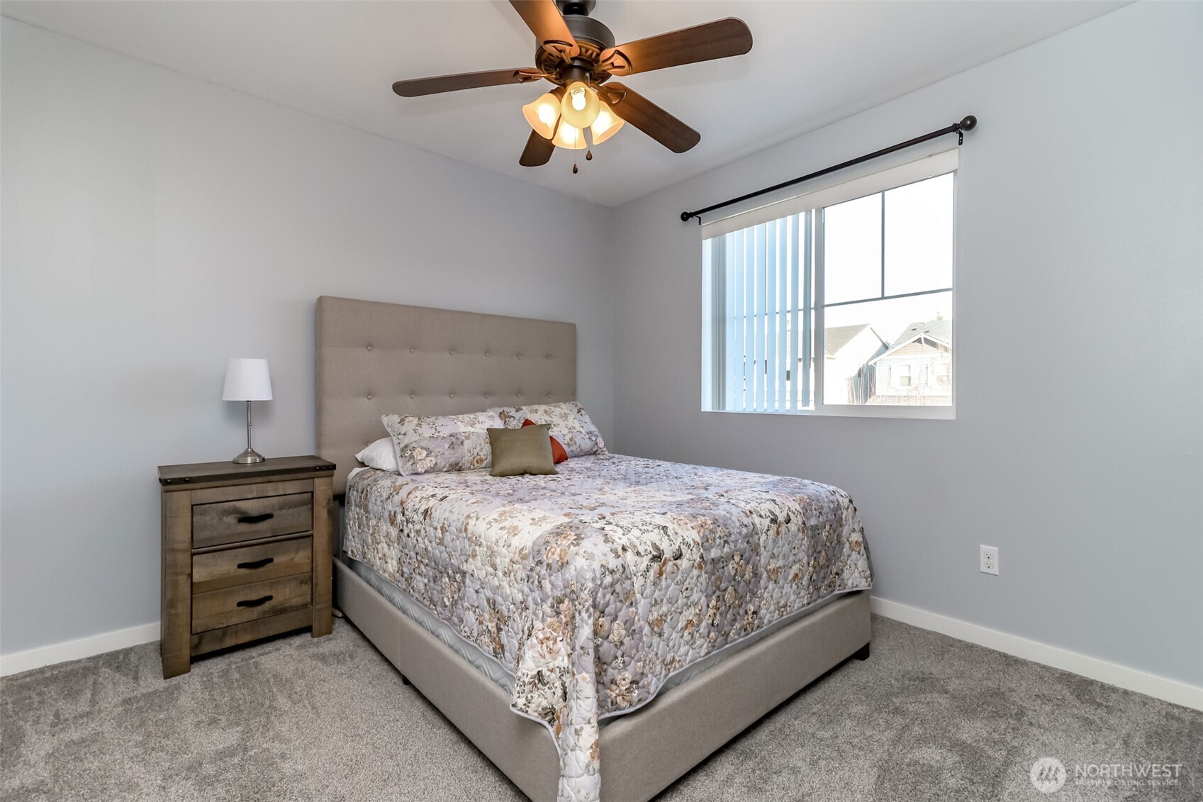 6820 9th Street East Fife, WA 98424 - Photo 21 of 40 a bedroom with a bed and a chandelier