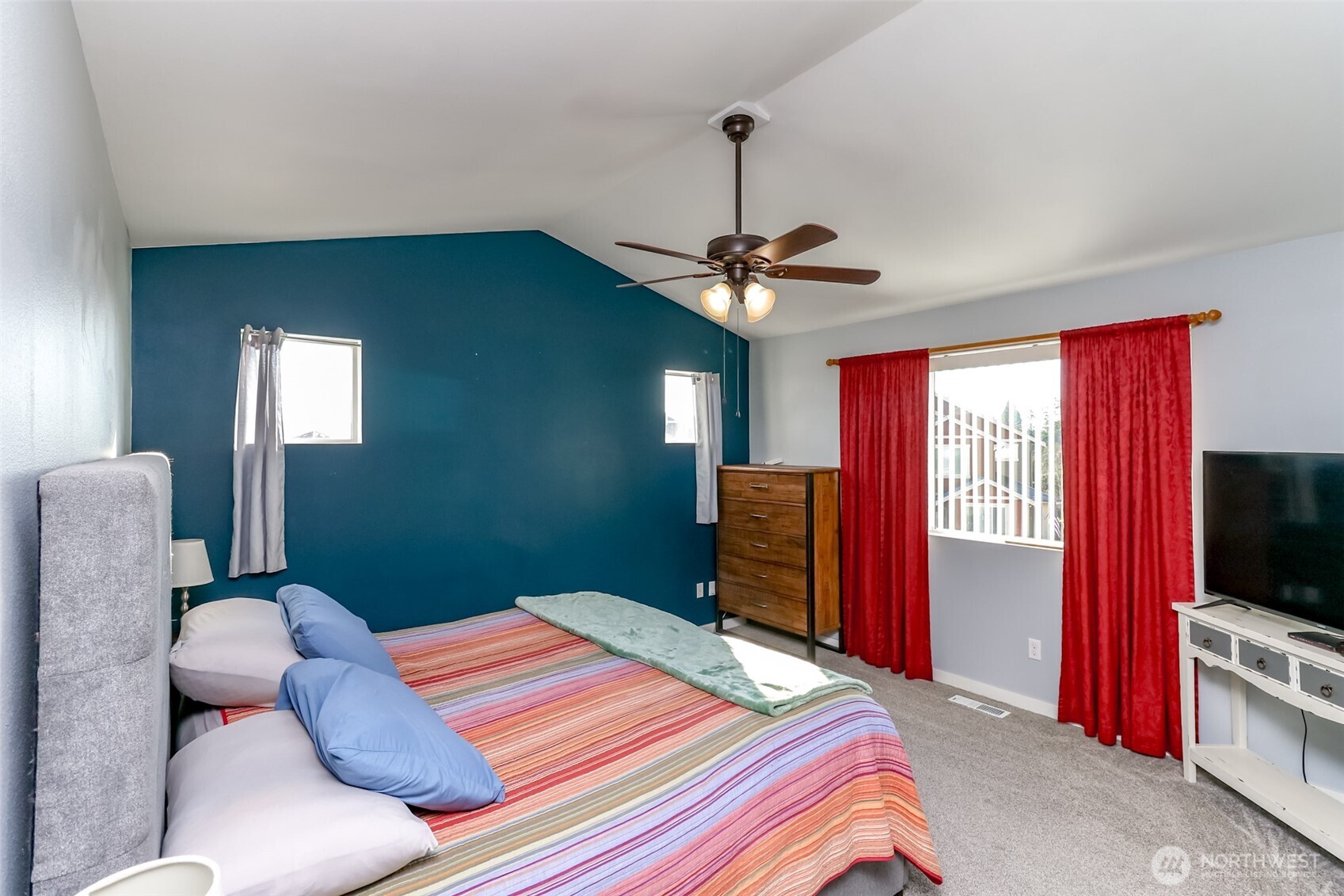 6820 9th Street East Fife, WA 98424 - Photo 26 of 40 a bedroom with a bed and a flat screen tv