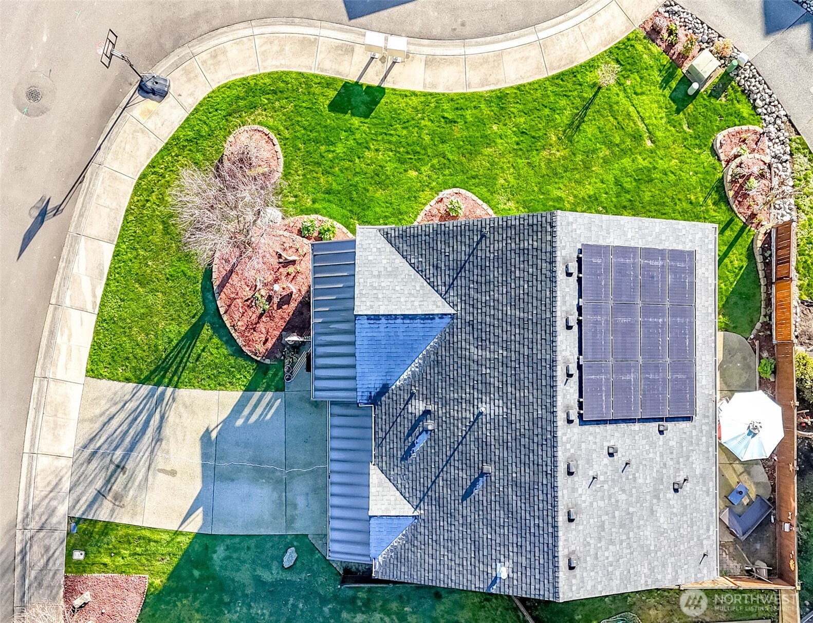 6820 9th Street East Fife, WA 98424 - Photo 33 of 40 an aerial view of a house with garden space and outdoor seating