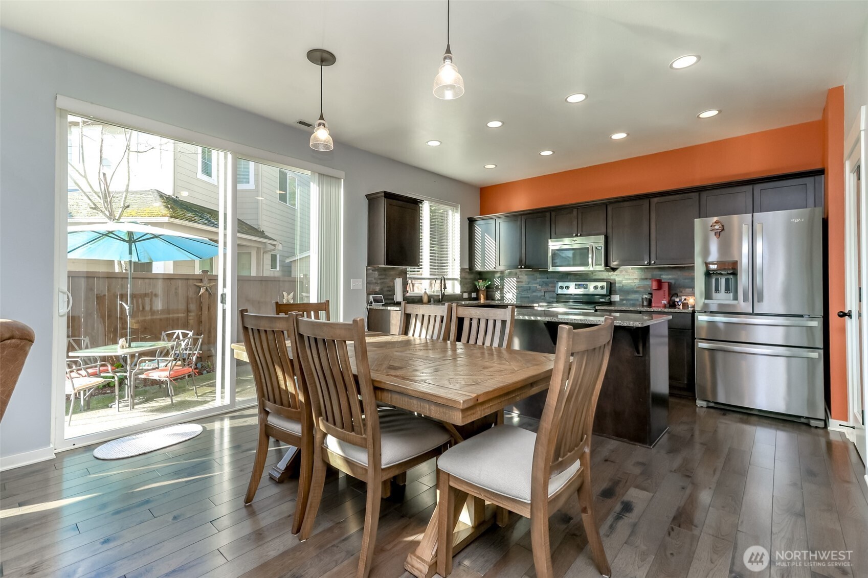 6820 9th Street East Fife, WA 98424 - Photo 7 of 40 a kitchen with stainless steel appliances granite countertop a refrigerator a stove top oven a sink with island and chairs