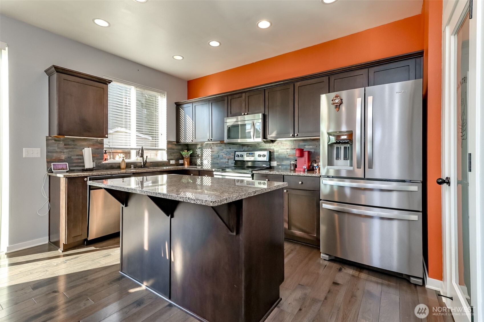 6820 9th Street East Fife, WA 98424 - Photo 10 of 40 a kitchen with stainless steel appliances granite countertop a refrigerator a sink dishwasher a stove with wooden cabinets and wooden floor