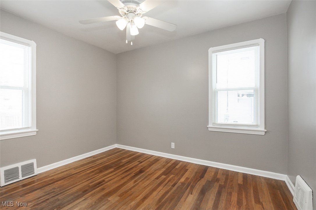 12328 Granger Road Cleveland, OH 44125 - Photo 13 of 37 Empty room featuring dark wood-type flooring and baseboards