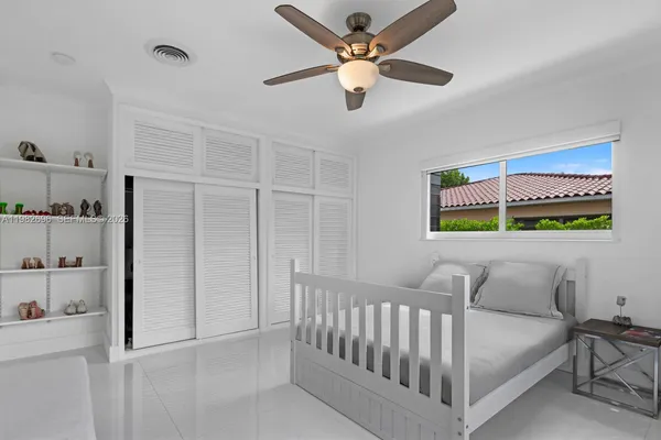 a bedroom with furniture and a window