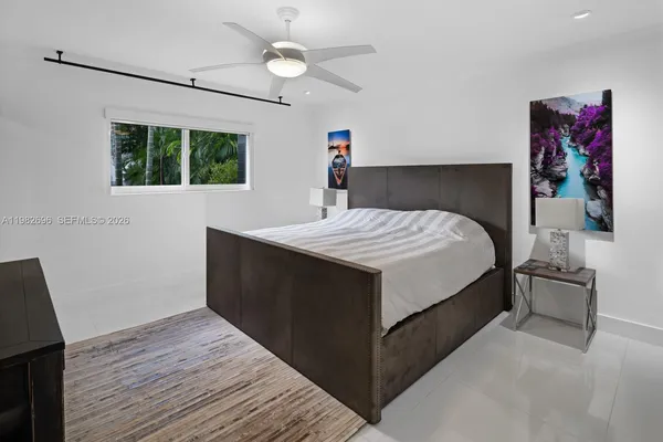 a bed sitting in a bedroom next to a window